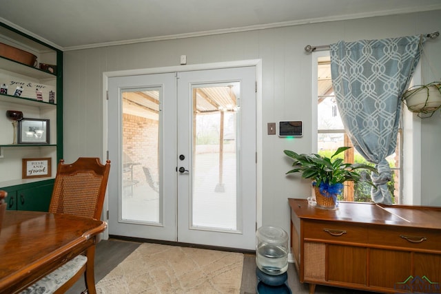 entryway featuring french doors, wood finished floors, and crown molding