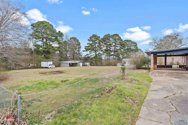 view of yard featuring an outbuilding and fence