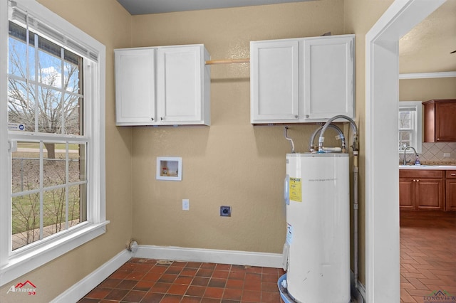 laundry room featuring hookup for an electric dryer, a sink, baseboards, water heater, and cabinet space