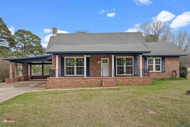 view of front of house featuring a chimney, covered porch, concrete driveway, a carport, and a front lawn