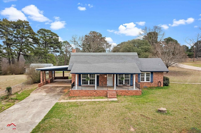 view of front of property with a shingled roof, covered porch, a front yard, crawl space, and a carport