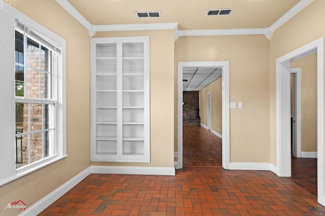 interior space featuring crown molding, visible vents, and baseboards