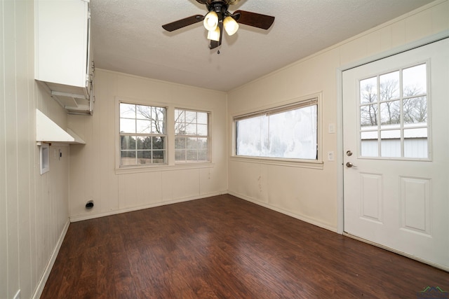 interior space featuring ceiling fan, hookup for a washing machine, a textured ceiling, dark hardwood / wood-style flooring, and hookup for an electric dryer