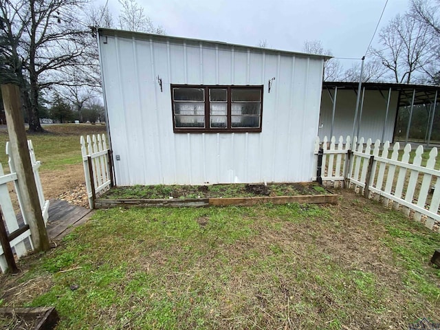 view of side of home with a lawn