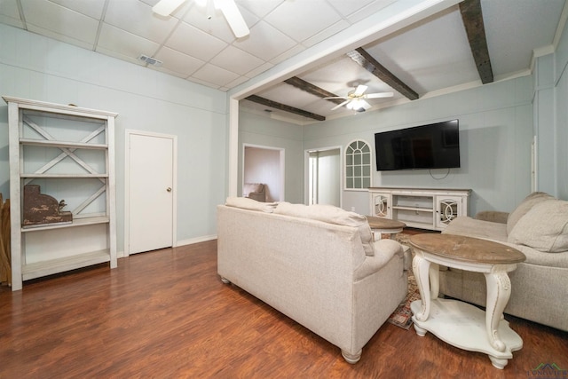 living room featuring dark wood-type flooring, beamed ceiling, ceiling fan, and a paneled ceiling