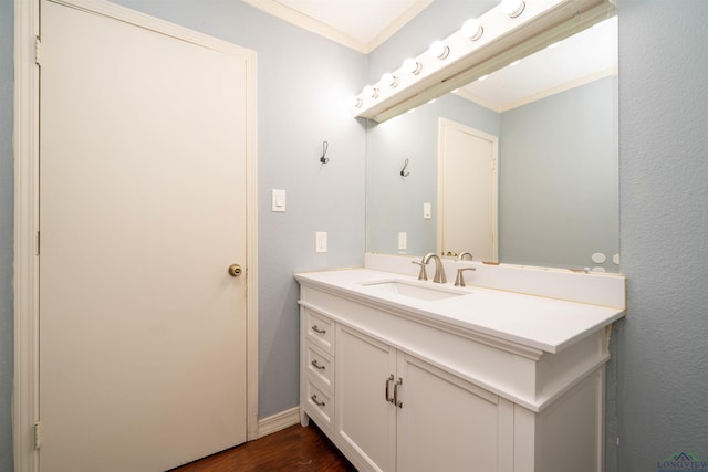 bathroom with vanity, wood-type flooring, and ornamental molding