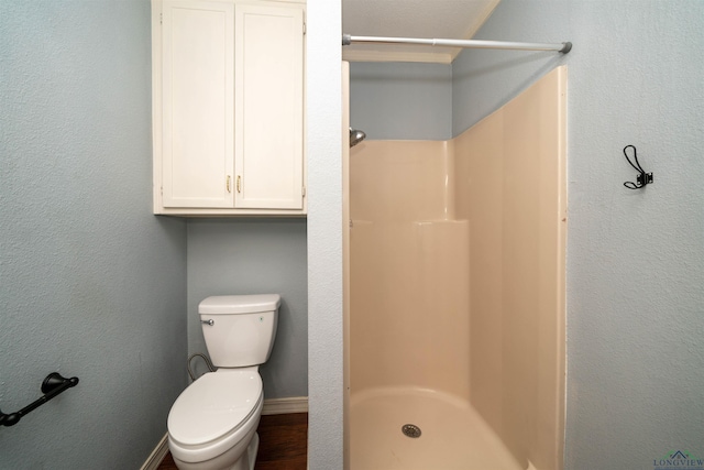 bathroom featuring toilet and a shower