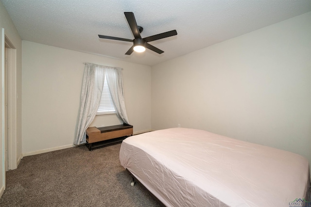 bedroom featuring ceiling fan, a textured ceiling, and dark colored carpet