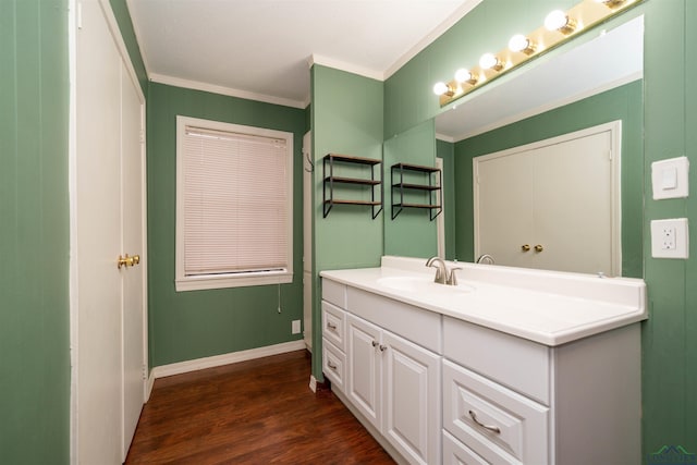 bathroom with wood-type flooring, ornamental molding, and vanity