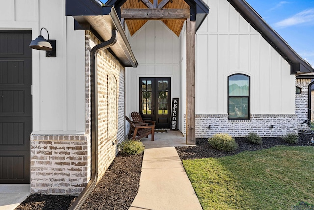 entrance to property with a lawn and french doors