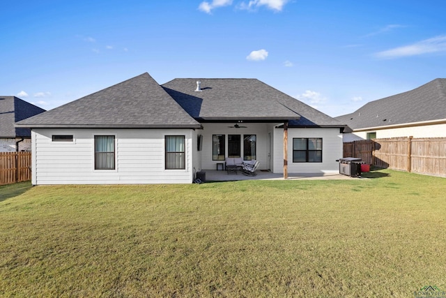 rear view of property featuring a patio area, a lawn, and ceiling fan