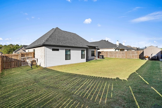 back of house with a lawn