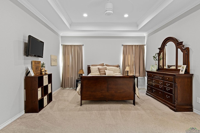 bedroom with ceiling fan, crown molding, a tray ceiling, and light carpet