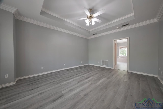 519 Hideaway Ln E, Hideaway, TX 75771 - spare room featuring visible vents, ceiling fan, wood finished floors, and a raised ceiling