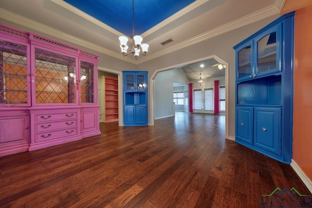 unfurnished dining area with a raised ceiling, crown molding, dark hardwood / wood-style floors, and a notable chandelier