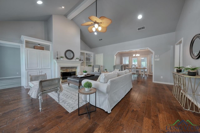 519 Hideaway Ln E, Hideaway, TX 75771 - living area featuring visible vents, arched walkways, a fireplace, ceiling fan with notable chandelier, and high vaulted ceiling