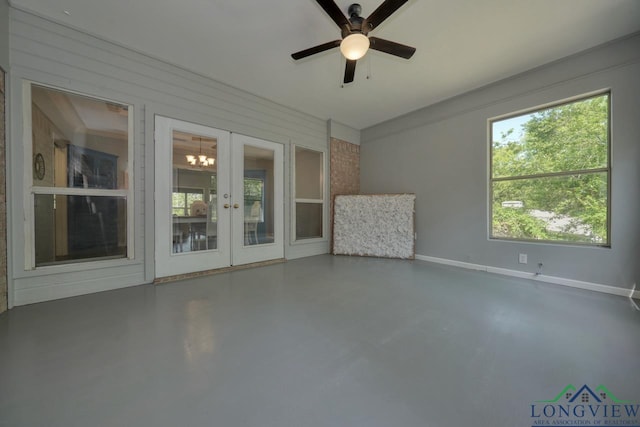 519 Hideaway Ln E, Hideaway, TX 75771 - interior space with finished concrete flooring, ceiling fan with notable chandelier, and french doors