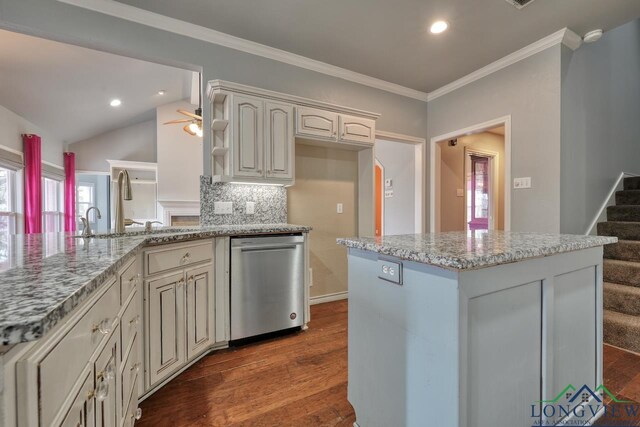 kitchen with dark hardwood / wood-style floors, dishwasher, backsplash, light stone counters, and crown molding