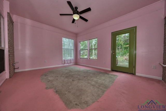 unfurnished living room with crown molding, ceiling fan, and carpet