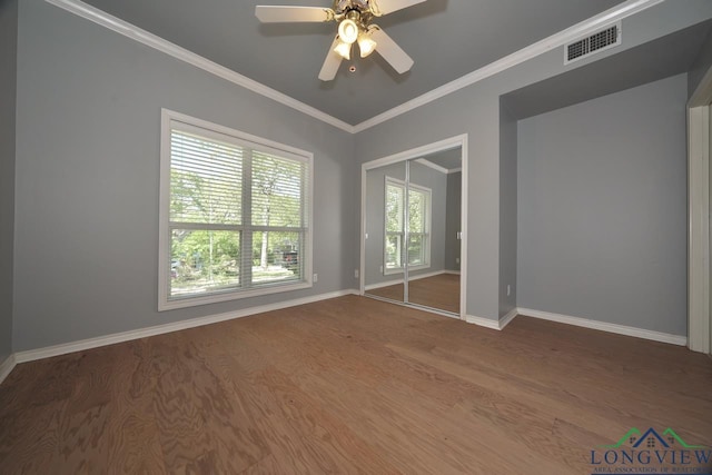 519 Hideaway Ln E, Hideaway, TX 75771 - spare room featuring ornamental molding, a ceiling fan, visible vents, wood finished floors, and baseboards