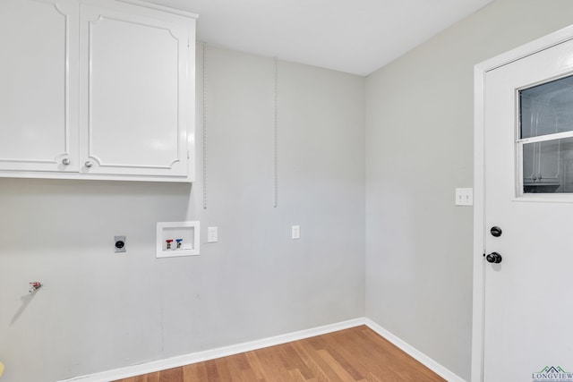 1702 Eastwood St, Longview, TX 75604 - laundry room with light wood-style flooring, hookup for a washing machine, cabinet space, and hookup for an electric dryer