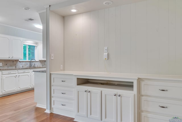 1702 Eastwood St, Longview, TX 75604 - bathroom with wood finished floors, ornamental molding, and decorative backsplash