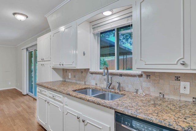 1702 Eastwood St, Longview, TX 75604 - kitchen featuring white cabinetry, crown molding, dishwasher, decorative backsplash, and light stone counters