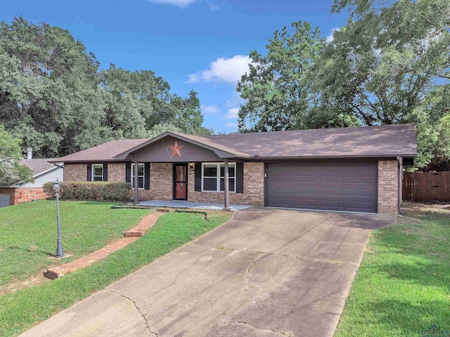 1702 Eastwood St, Longview, TX 75604 - single story home featuring brick siding, a garage, a porch, driveway, and roof with shingles