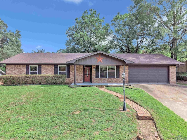 1702 Eastwood St, Longview, TX 75604 - single story home featuring an attached garage, brick siding, driveway, a front yard, and a porch