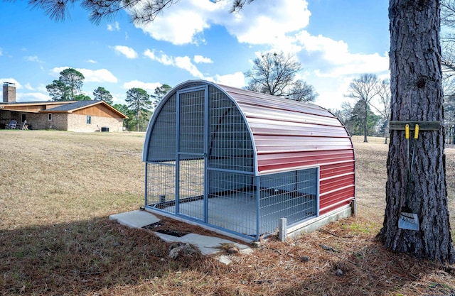 view of outbuilding featuring a yard