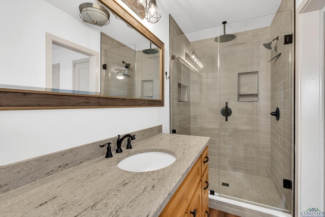 bathroom with vanity and a shower with shower door