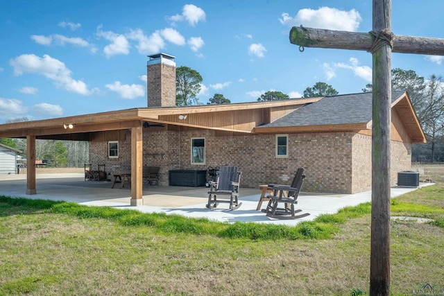 back of house featuring a yard and a patio