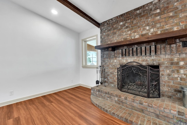 details featuring beamed ceiling, hardwood / wood-style flooring, and a fireplace