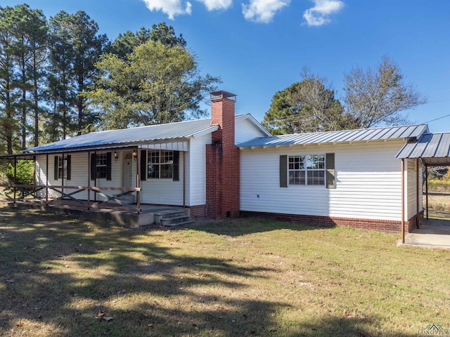 back of property featuring a porch and a lawn