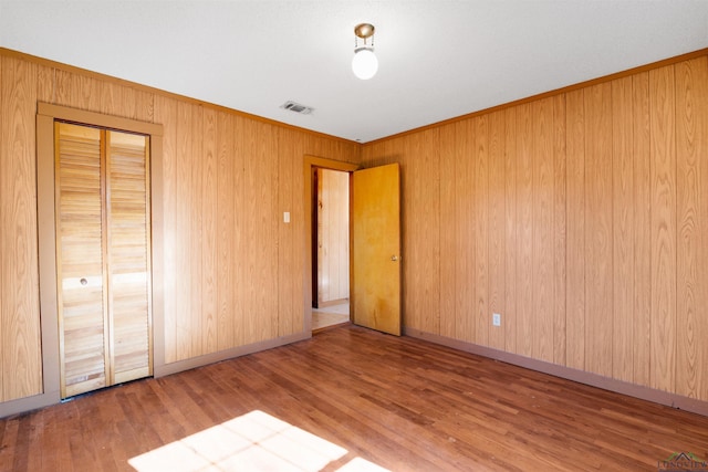 unfurnished bedroom featuring hardwood / wood-style floors and a closet