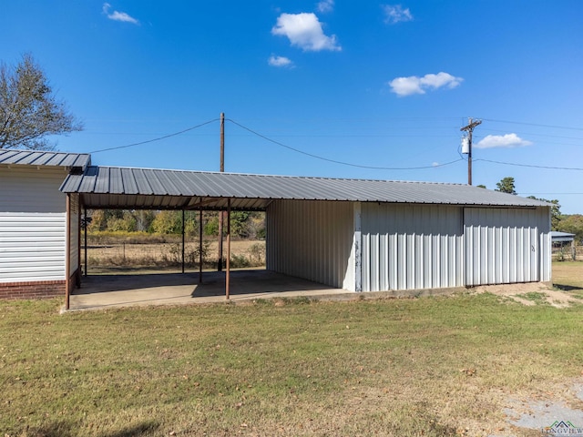 view of outbuilding featuring a lawn