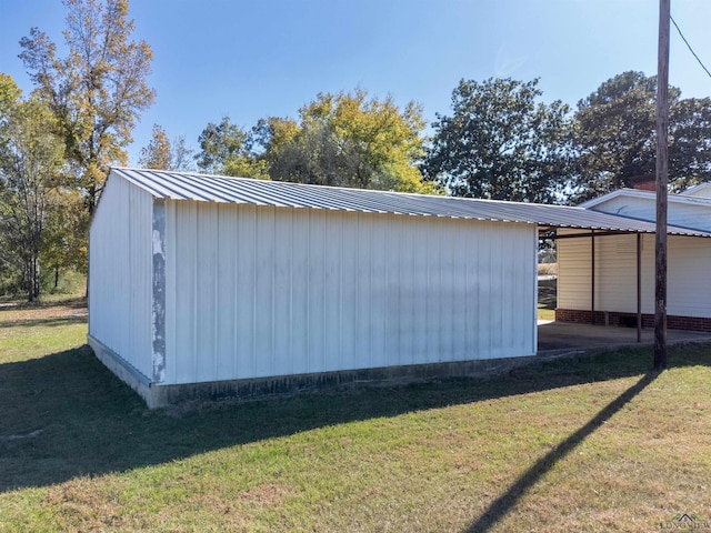 view of property exterior with an outdoor structure and a lawn