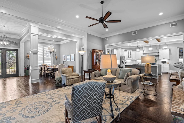 living room with dark wood-style floors, ornamental molding, and visible vents