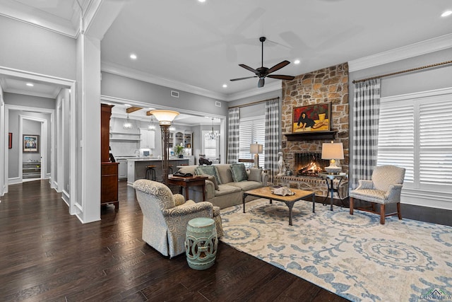 living room with a fireplace, dark wood finished floors, and crown molding