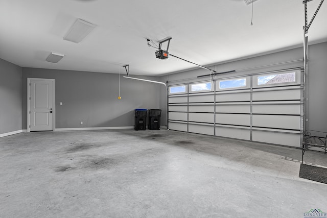 garage with a garage door opener and baseboards