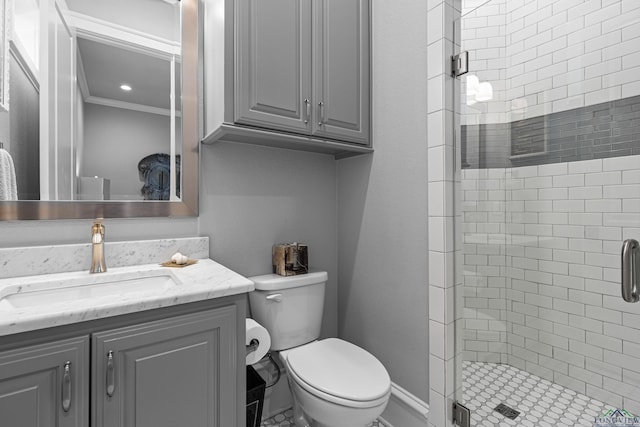 bathroom with toilet, a shower stall, ornamental molding, and vanity