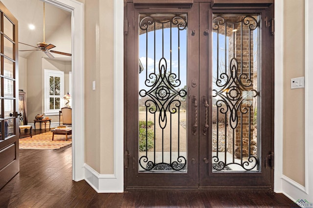 foyer with french doors, baseboards, and dark wood-style flooring