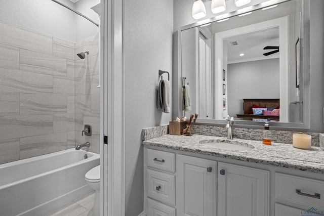 ensuite bathroom with connected bathroom, toilet, visible vents, vanity, and washtub / shower combination