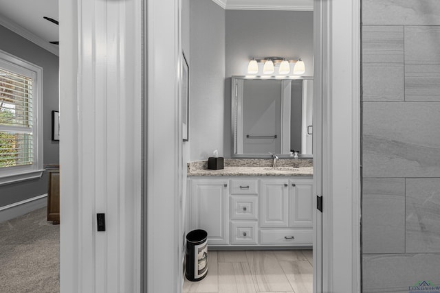 bathroom featuring ornamental molding and vanity