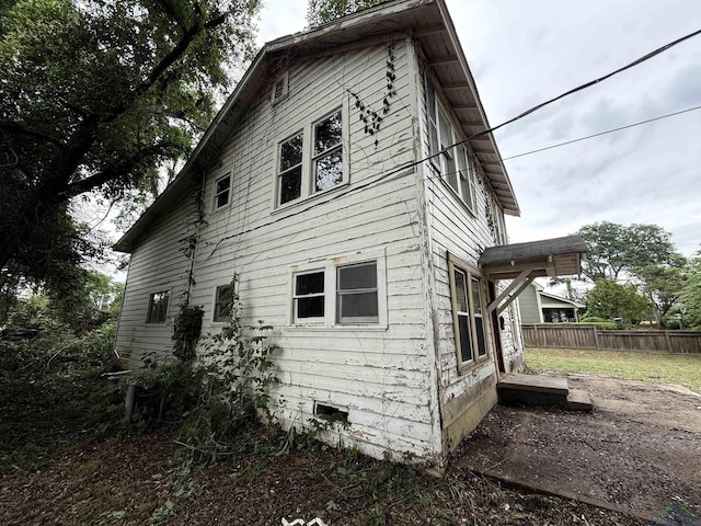 view of home's exterior with fence