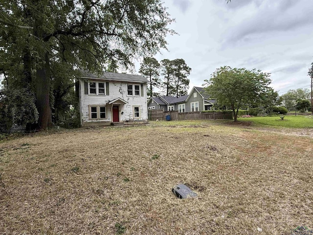 colonial inspired home with fence