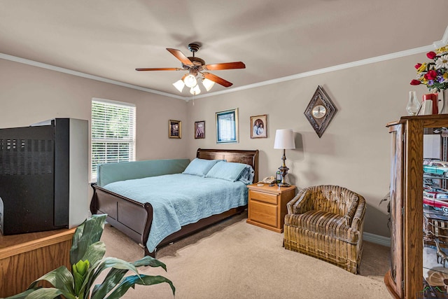 carpeted bedroom with ceiling fan and ornamental molding