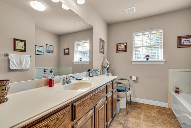 bathroom featuring vanity, toilet, and a bathtub