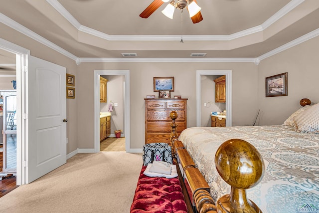 bedroom featuring a tray ceiling, connected bathroom, ceiling fan, and light carpet