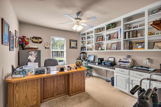 carpeted office featuring ceiling fan